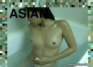 Slim Asian beauty showers lustily