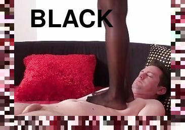 Black Lucy tramples Bobby's white body with her black stockings on the round bed.