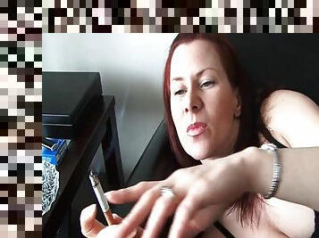 Pretty redhead smokes cigarette in close up porn