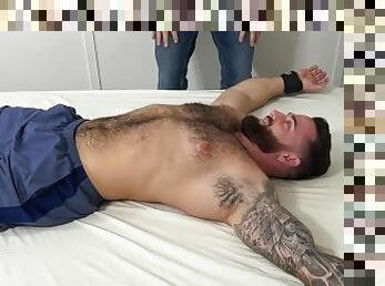 Bearded hunk Tommy B laughs while dom tickle torments him