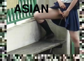 Asian pees on park bench