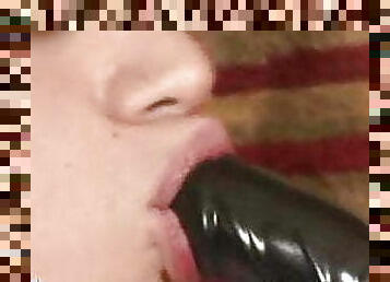 Impatient gay boy gobbling on a big black rubber cock