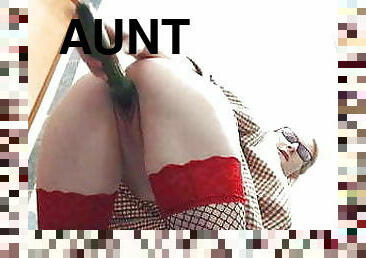 Aunt in fishnets uses a cucumber on herself