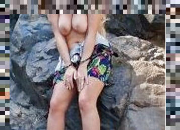 Horny blonde with big natural boobs masturbates outdoors at the waterfall