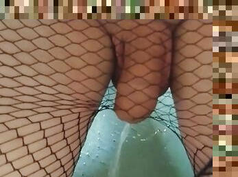 Femboy in fishnet stockings pees and play with his piss