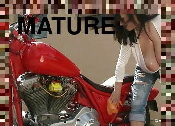 Bike washing - Brunette mature biker with monster jugs teasing topless outdoors