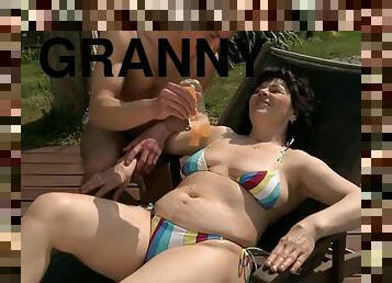 Chubby granny massaged and fucked near the pool