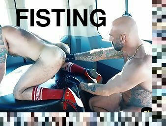Tattooed hunk in gloves fisting a studs ass in the van