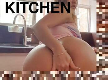 Latina plays with a dildo in the kitchen