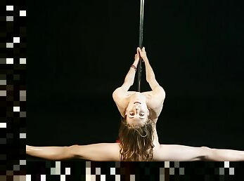 Gorgeous Nude Ballerina Dances On A Pole. Girl Dancer Spreads Her Flexible Long Legs Wide