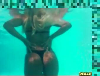 Bikini girl shows off her tits in the pool