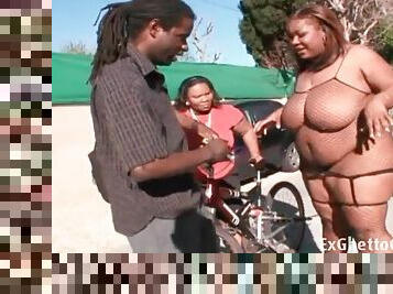 Fat black girl in fishnet lingerie sucks a dick