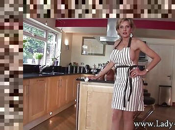Blonde MILF teases with her perfect body in the kitchen