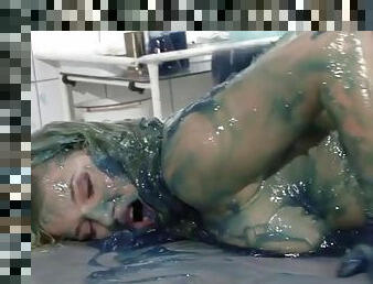 Naked babe in a hospital rubs blue goo into her body