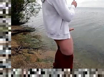 the guy jerks off his big beautiful dick by the lake