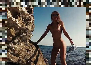 Traveling slut teases a videographer and fucks him on the beach