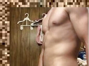 Young stud strips in the bathroom