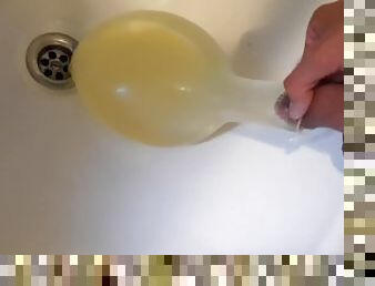 young german twink pissing in condom till its completely full and blown up like a baloon and jerking