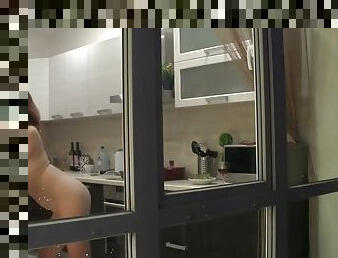 Watch my neighbors sexy naked girlfriend having fun in the kitchen