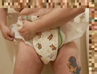 putting new diaper under soggy one