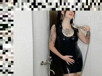 Fetish of latex and rubber. Dominatrix Nika takes a shower in a latex dress.