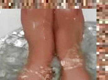 Sexy pantyhose feet in the bathroom, painted red nylon toes, wet nylon, wet feet, dressed in bath