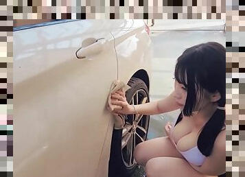 Seductive Korean woman washing her car